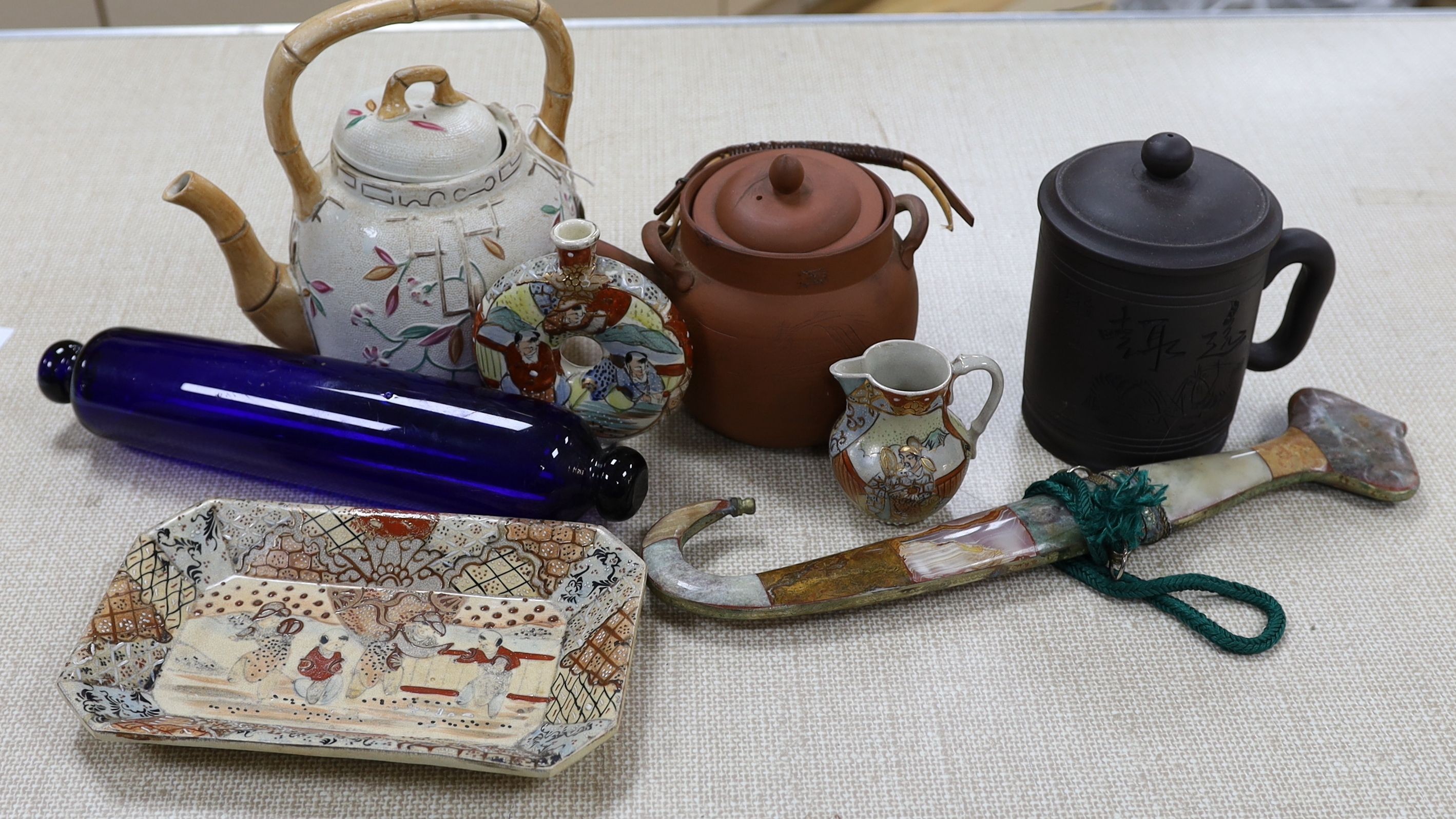 A group of Japanese Satsuma pottery, a Japanese red stoneware teapot, a Chinese Yixing jar and cover, a Middle Eastern dagger and a blue glass rolling pin